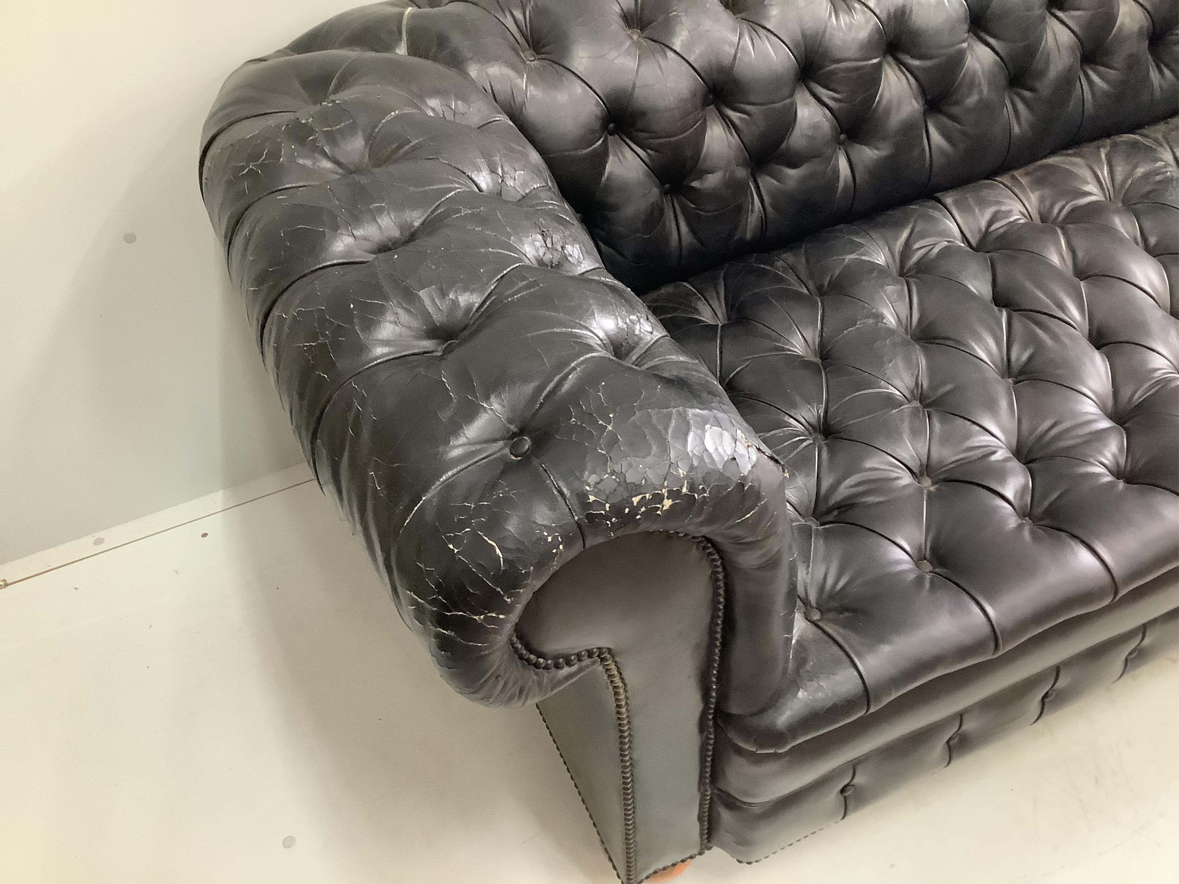 A Victorian style black leather button back chesterfield settee, width 230cm, depth 90cm, height 73cm. Condition - poor